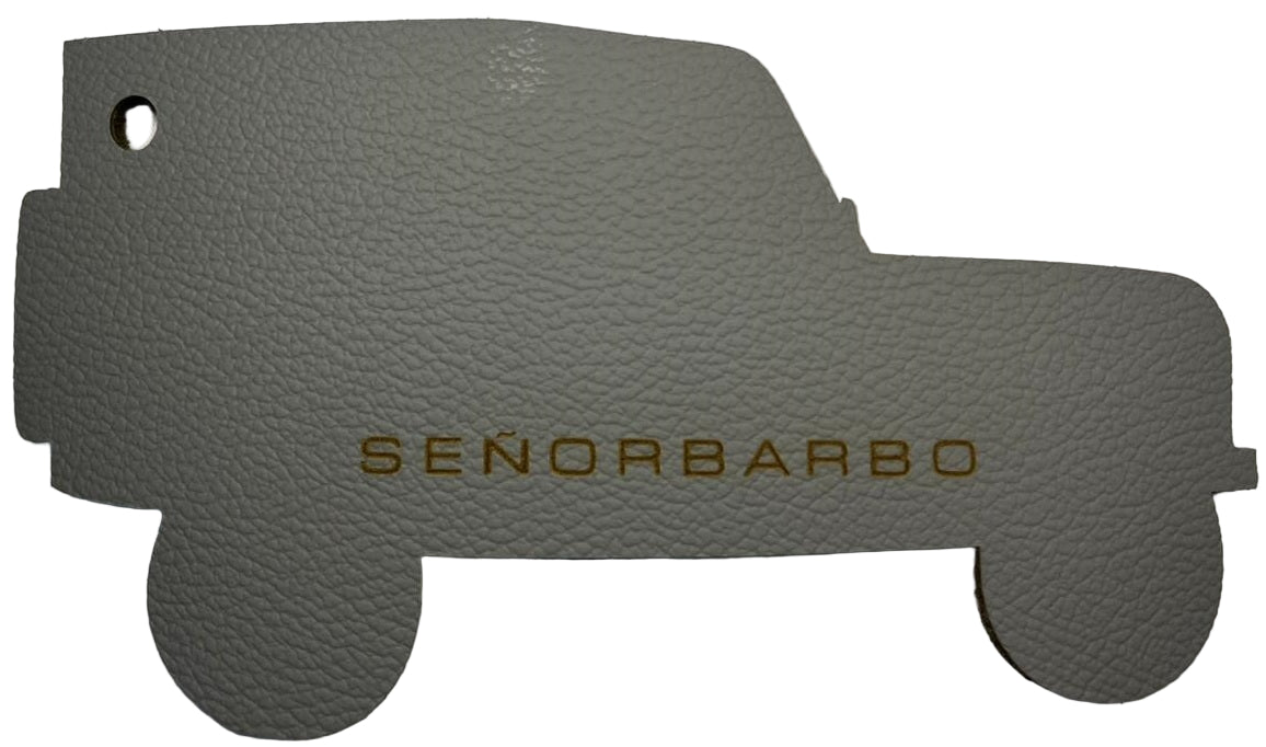Gray car mat with &#39;SEÑORBARBO&#39; branding on a white background