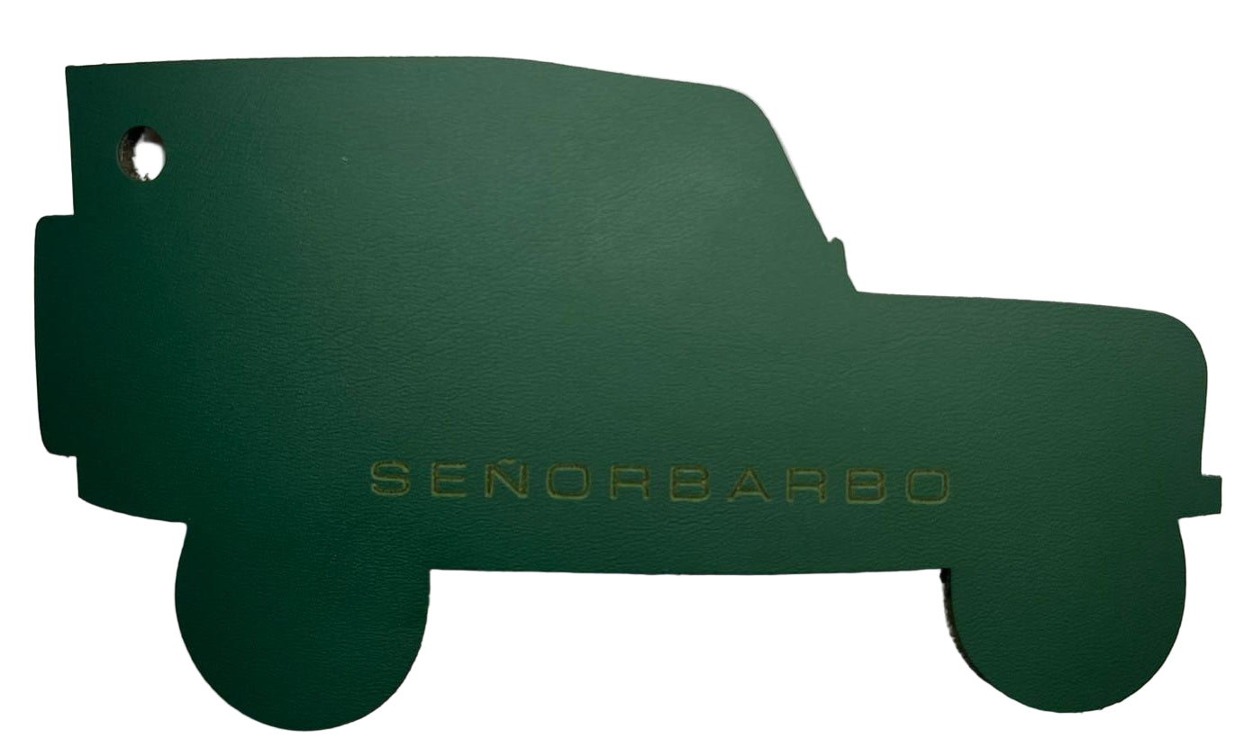 Green metal truck-shaped object with &#39;Senor Barbo&#39; branding on a white background
