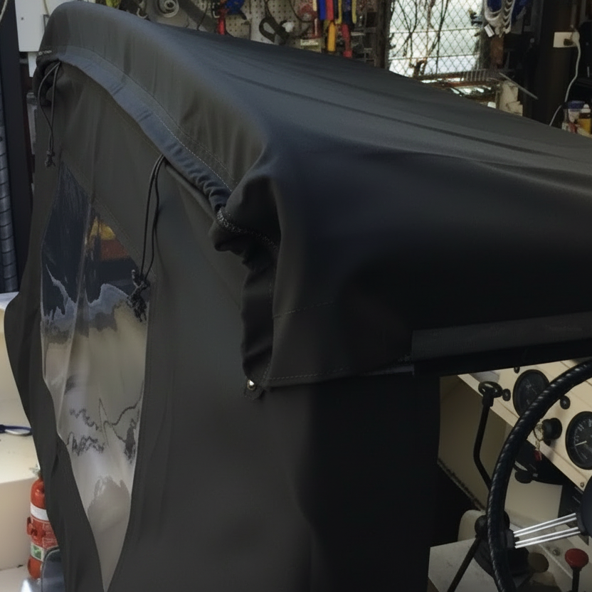 Black car seat cover on a vehicle in a workshop setting