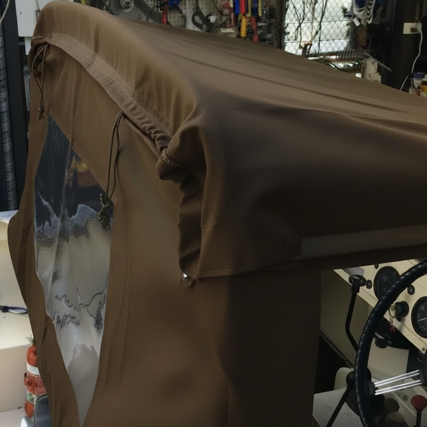 Brown cover over a vehicle seat in a workshop setting
