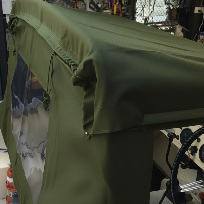 Green cover over a vehicle seat in a workshop setting