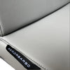 Close-up of a gray leather seat with &#39;Senoobarbo&#39; branding.