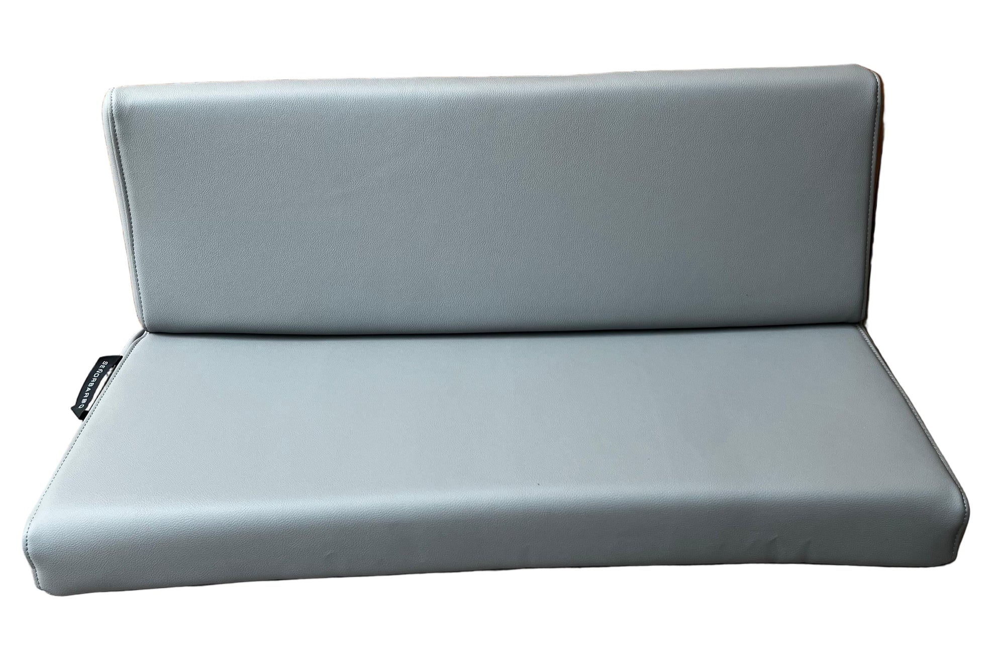 Gray outdoor cushion against a wooden fence