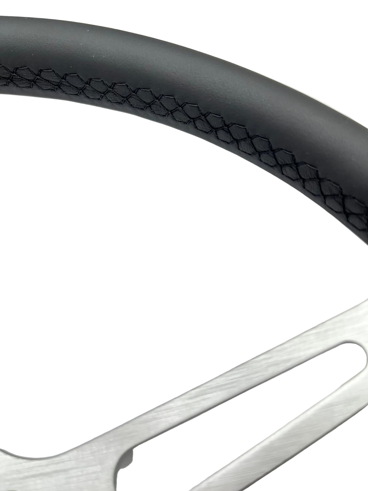 Close-up of a car wheel with a detailed tread pattern on a white background