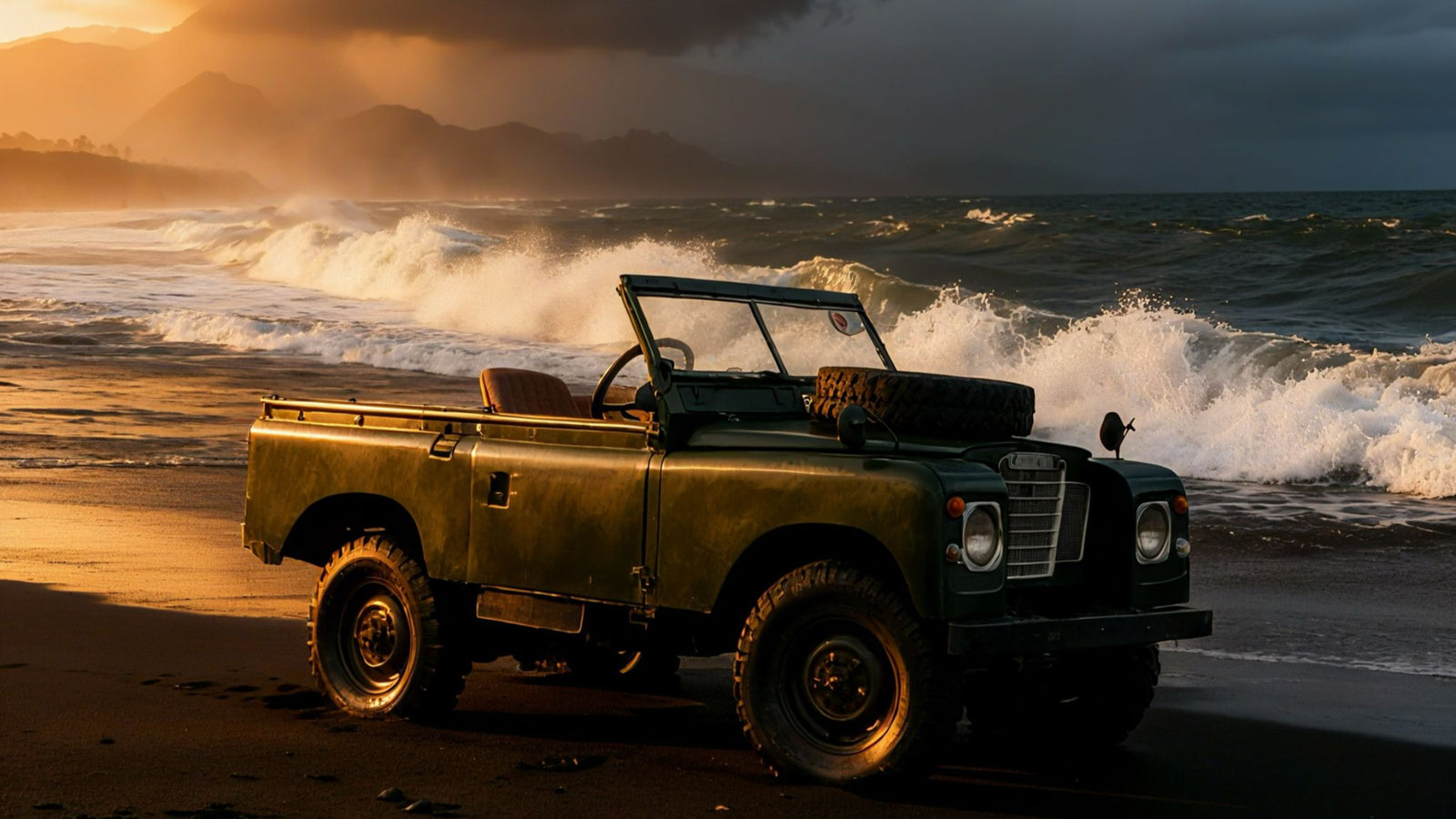 Vintage green Land Rover on a beach with dramatic ocean waves and sunset sky