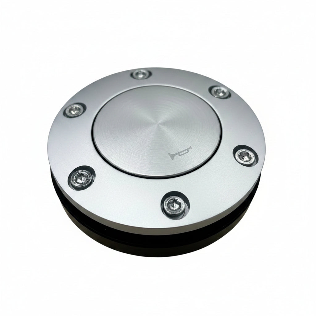 Metallic circular object with screws on a wooden surface