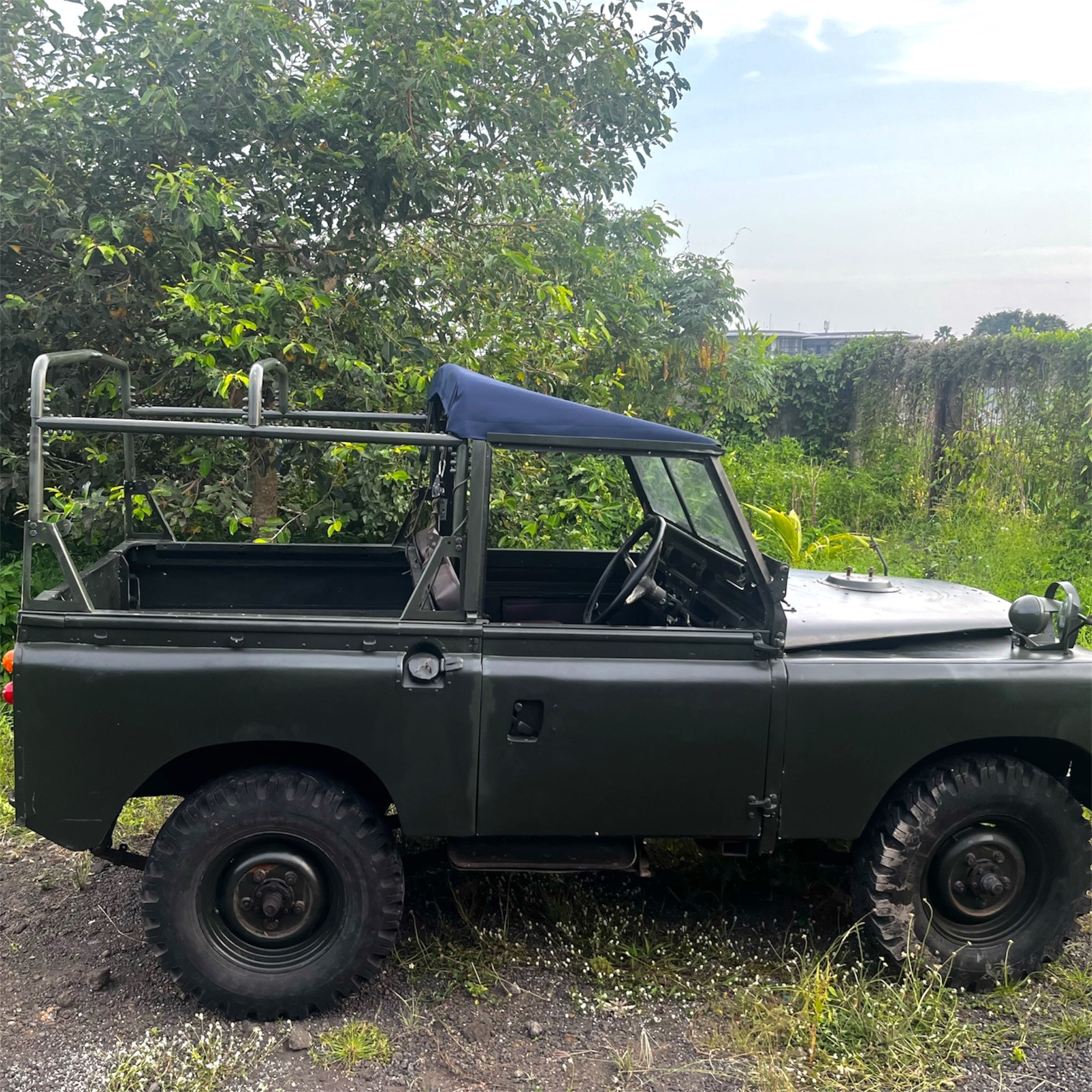Vintage green jeep with a roof rack in a natural setting
