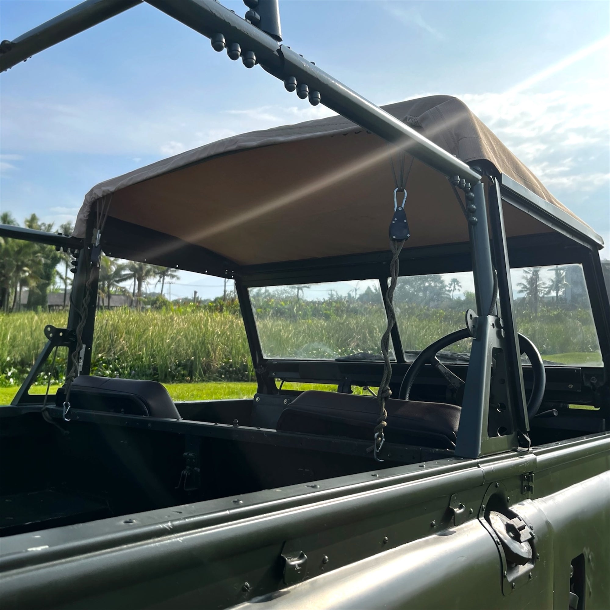 Open-top vehicle with a canopy in a natural setting