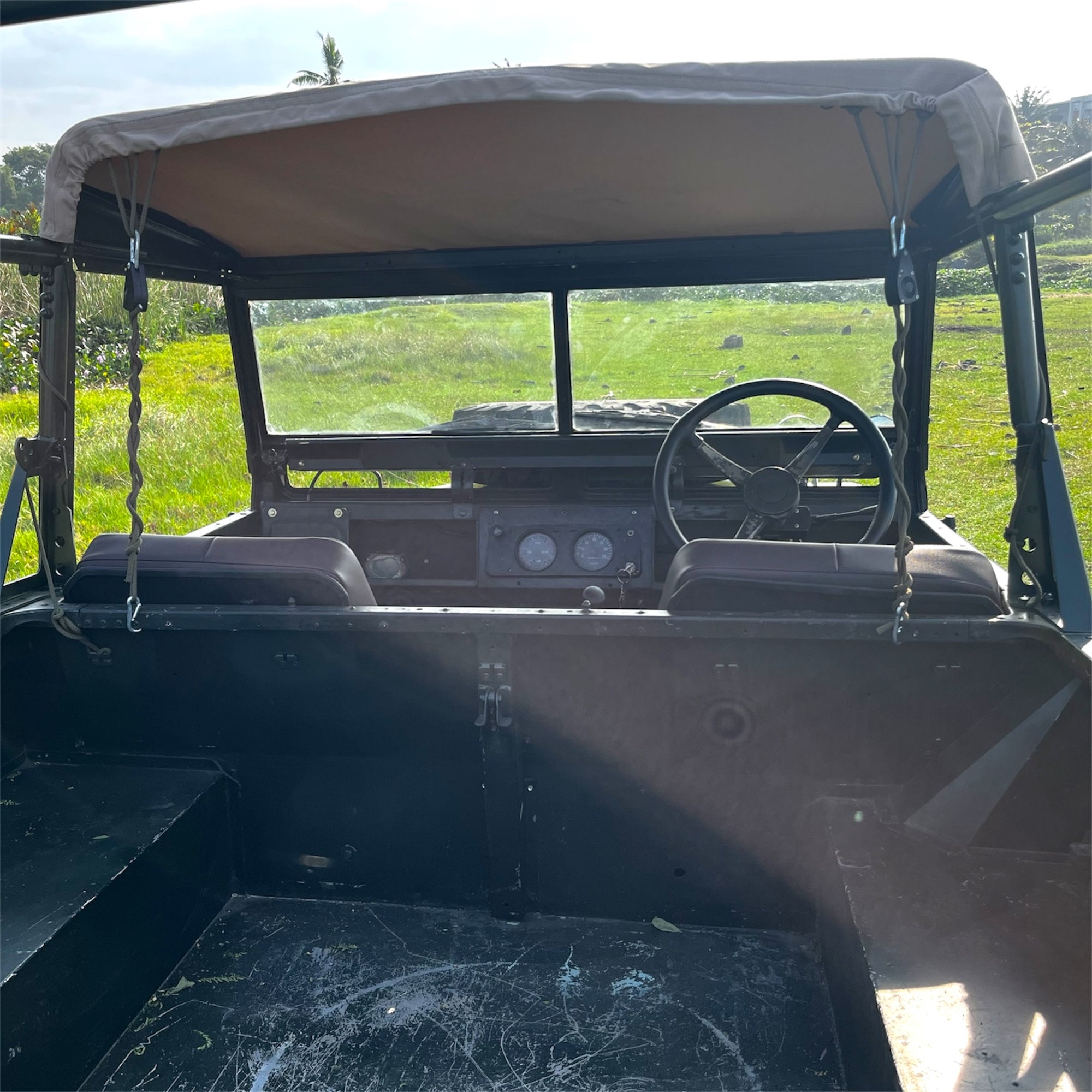 Vintage vehicle interior with a grassy field outside