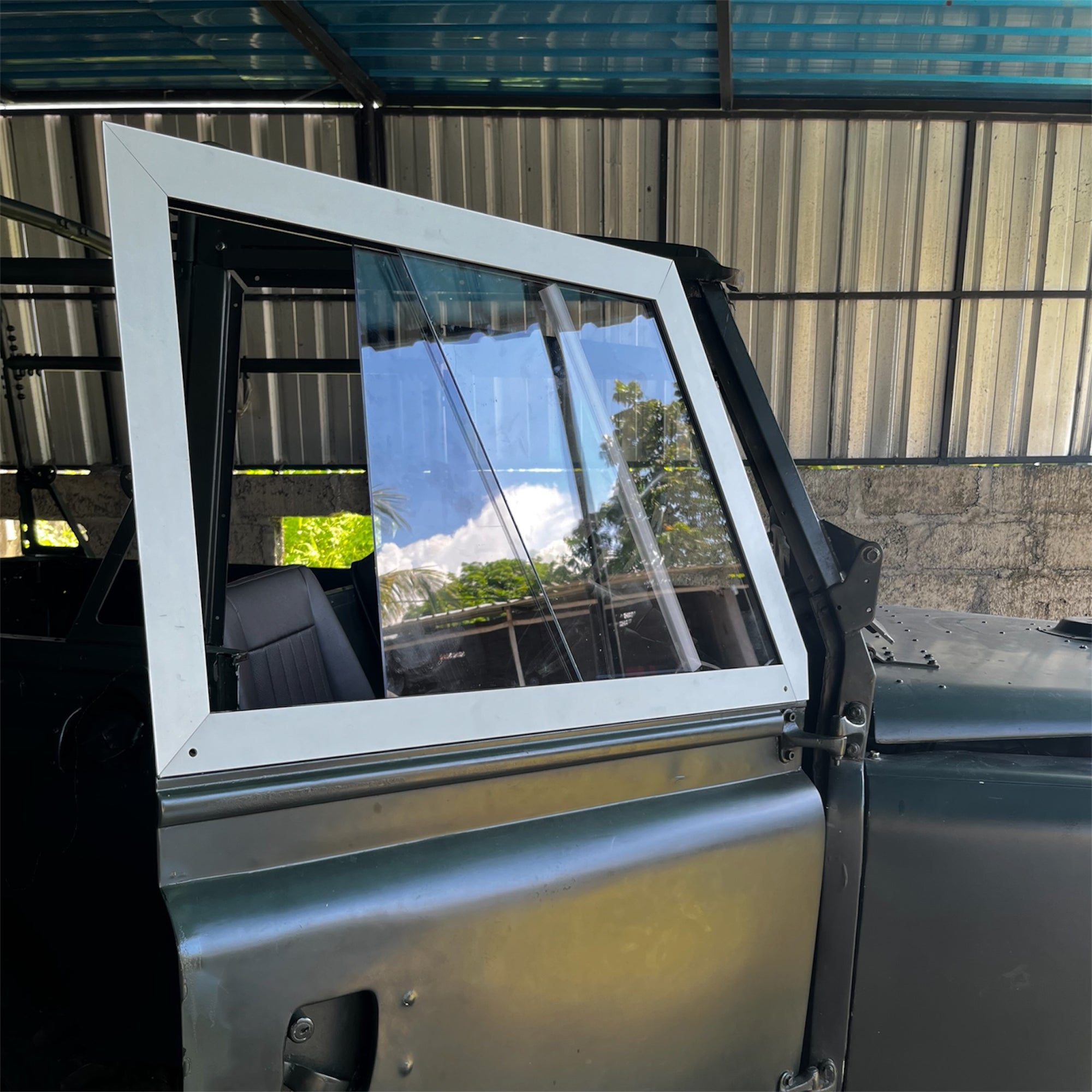 Car door with a reflective window in an indoor setting