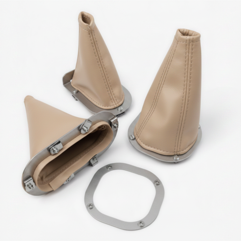 Beige leather gear shift boot and shifter with metal components on a white background
