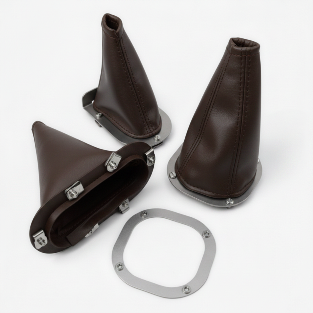 Set of brown leather gear shift boot covers with metal hardware on a white background