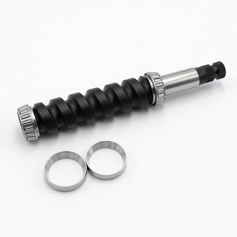 A black and silver mechanical component with two separate silver metal rings placed below it on a clean white background.