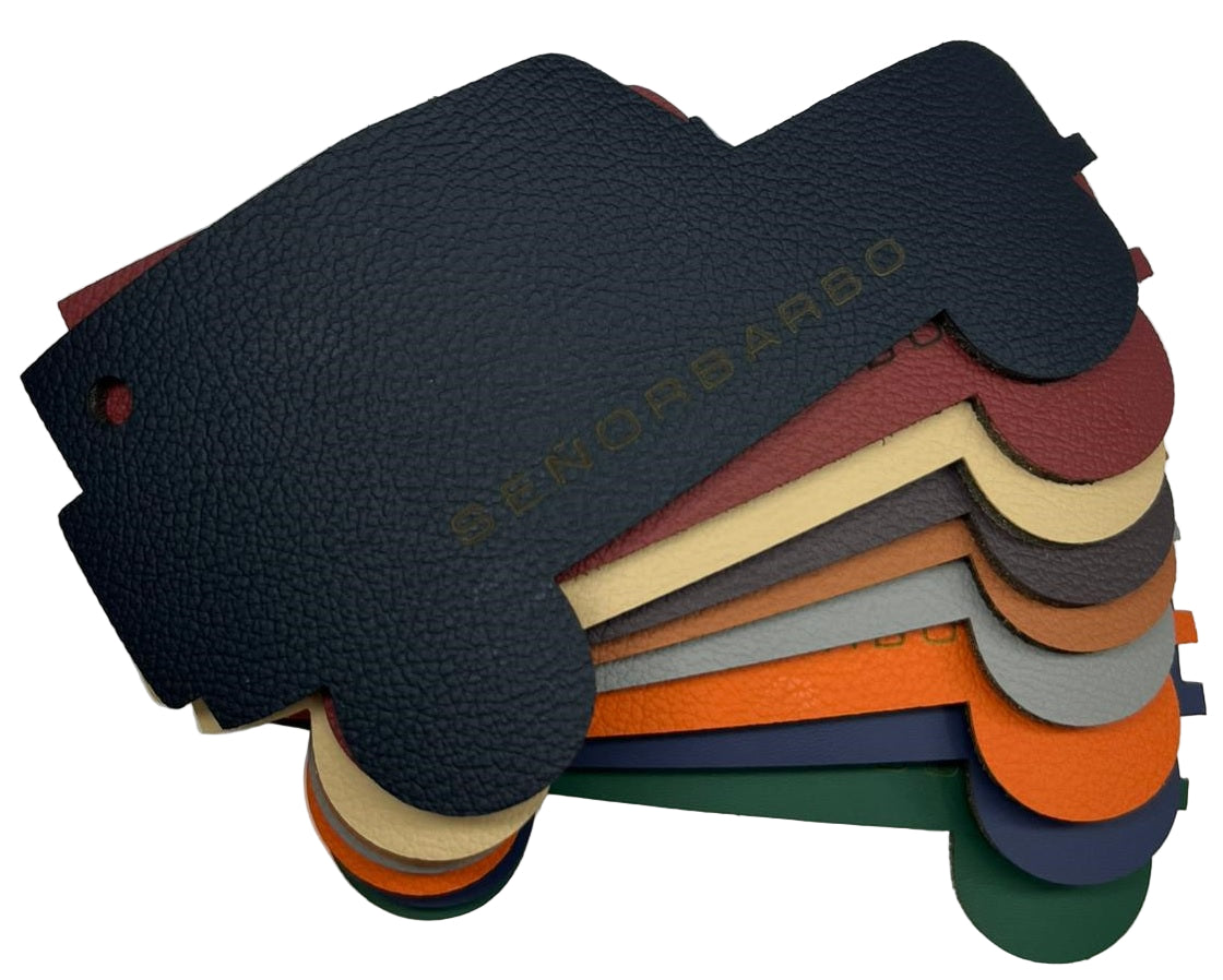 Stack of leather samples in various colors with &#39;senorbarbo&#39; branding.