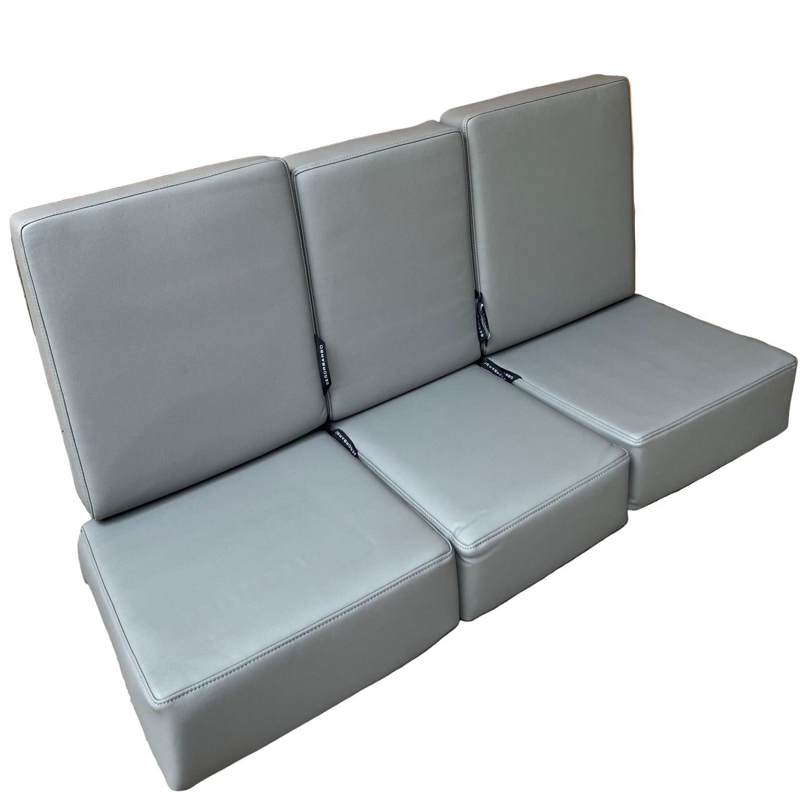 Elephant seats set against a wooden fence on a concrete surface