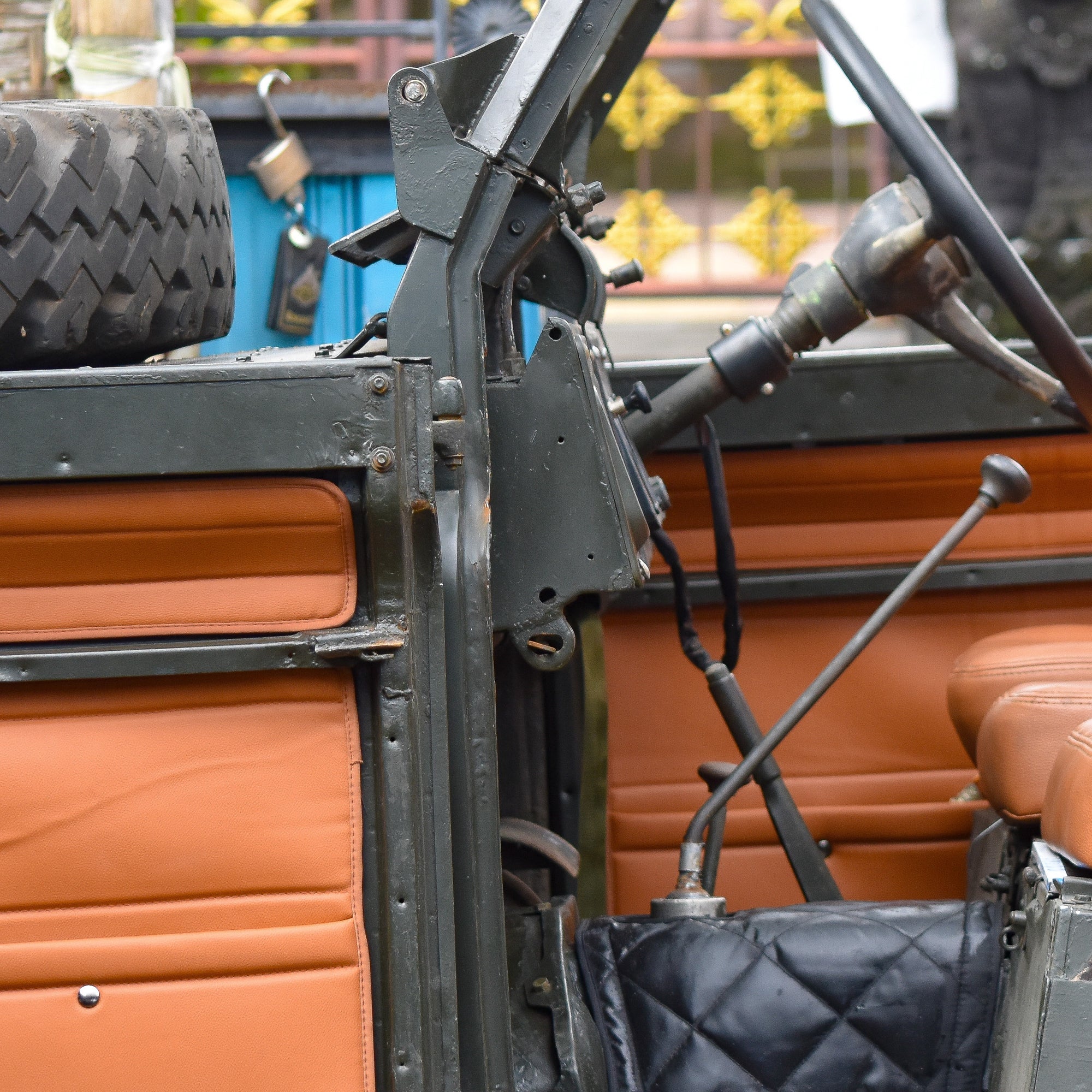 Close-up of an old-fashioned vehicle interior with leather seats and mechanical components.